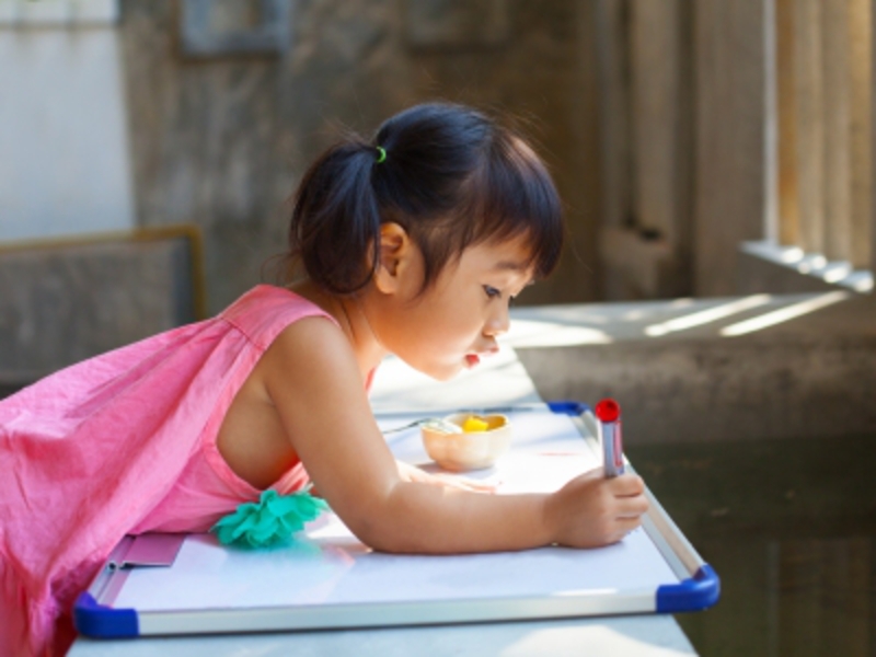 Child Writing on Whiteboard