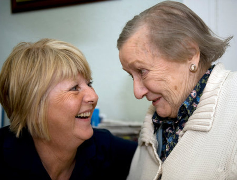 elderly woman with staff member