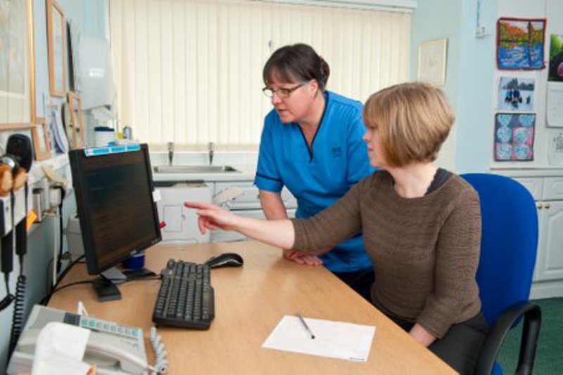 Staff looking at computer screen